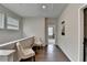 A light and bright hallway with neutral paint, hardwood floors and comfortable seating at 747 Topsail Ln, Alpharetta, GA 30005