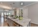 Well-appointed kitchen island with granite countertops, stainless steel sink and appliances at 747 Topsail Ln, Alpharetta, GA 30005