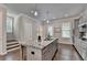 Stylish kitchen island with granite countertop, seating, and stainless steel sink at 747 Topsail Ln, Alpharetta, GA 30005