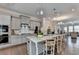 Modern kitchen with stainless appliances, granite countertops, and an eat-in island at 747 Topsail Ln, Alpharetta, GA 30005
