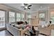 Bright living room features large windows, a fireplace, and hardwood floors at 747 Topsail Ln, Alpharetta, GA 30005