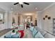 Bright living room featuring hardwood floors, a ceiling fan, and comfortable seating at 747 Topsail Ln, Alpharetta, GA 30005