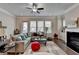 Spacious living room with lots of natural light, a fireplace, and hardwood floors at 747 Topsail Ln, Alpharetta, GA 30005