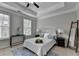 Comfortable main bedroom with tray ceiling, ceiling fan, neutral colors, and an area rug at 747 Topsail Ln, Alpharetta, GA 30005