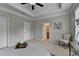 Bright bedroom with a ceiling fan, 2 closets, and an open doorway to the bathroom at 747 Topsail Ln, Alpharetta, GA 30005