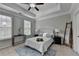 Serene main bedroom with tray ceiling, ceiling fan, neutral color scheme, and natural light at 747 Topsail Ln, Alpharetta, GA 30005