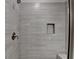 Modern shower with gray tile, a shower head and shampoo shelf at 747 Topsail Ln, Alpharetta, GA 30005