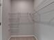 A walk-in closet showcasing ample storage with white wire shelving and neutral walls at 747 Topsail Ln, Alpharetta, GA 30005