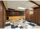 Basement with paneled walls, black and white tiled floor, and built-in storage at 900 Fleetwood Cir, Atlanta, GA 30311