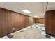 Spacious basement with wood paneling and a unique tiled floor pattern at 900 Fleetwood Cir, Atlanta, GA 30311