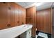 Basement half-bathroom with paneling, black and white tiled floor, and simple vanity at 900 Fleetwood Cir, Atlanta, GA 30311