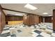 Spacious basement with black-and-white tile and wood-paneled walls, ready to be refinished at 900 Fleetwood Cir, Atlanta, GA 30311