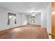 Spacious bedroom with neutral carpeting, ceiling fan, and natural light from windows with security bars at 900 Fleetwood Cir, Atlanta, GA 30311