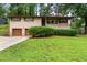 Charming brick ranch home featuring an attached two-car garage and well-maintained lawn at 900 Fleetwood Cir, Atlanta, GA 30311