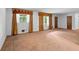 Bright living room featuring neutral carpeting and natural light from windows with unique metal security bars at 900 Fleetwood Cir, Atlanta, GA 30311