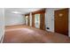 Bright living room featuring neutral carpeting and natural light from windows with unique metal security bars at 900 Fleetwood Cir, Atlanta, GA 30311