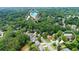 Aerial view of the neighborhood highlighting a home and the community swimming pool at 10645 Tuxford Dr, Alpharetta, GA 30022