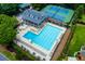 Aerial view of the community swimming pool with lounge chairs and a clubhouse at 10645 Tuxford Dr, Alpharetta, GA 30022