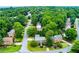 An aerial view of the property showcasing lush landscaping and surrounding greenery at 10645 Tuxford Dr, Alpharetta, GA 30022