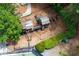 Aerial view of a wooden playset with swings and climbing features in a fenced yard at 10645 Tuxford Dr, Alpharetta, GA 30022