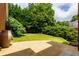 A lush, green backyard with mature trees and a concrete patio, perfect for outdoor entertaining at 10645 Tuxford Dr, Alpharetta, GA 30022