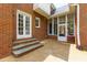A backyard with a patio, screened-in porch, and brick exterior at 10645 Tuxford Dr, Alpharetta, GA 30022
