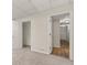 A partially carpeted and partially laminate floored basement with closet and doorway at 10645 Tuxford Dr, Alpharetta, GA 30022