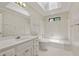 Bathroom featuring ample counter space, wallpaper, and tiled shower at 10645 Tuxford Dr, Alpharetta, GA 30022