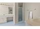 Well-lit bathroom featuring a shower with glass door, spacious vanity, and ceramic tile flooring at 10645 Tuxford Dr, Alpharetta, GA 30022