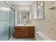 Bathroom featuring a vanity with wood cabinets, floral wallpaper and shower with glass doors at 10645 Tuxford Dr, Alpharetta, GA 30022