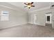 Large bedroom with a tray ceiling, carpeted floors, and natural light, creates a serene atmosphere at 10645 Tuxford Dr, Alpharetta, GA 30022