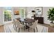 Bright dining room featuring a dark wood table, comfortable seating, and natural light from large windows at 10645 Tuxford Dr, Alpharetta, GA 30022