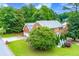 Aerial view of a brick home showcasing its well-maintained yard, mature trees, and convenient driveway access at 10645 Tuxford Dr, Alpharetta, GA 30022