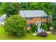 Charming two-story brick home with a well-manicured lawn and mature trees at 10645 Tuxford Dr, Alpharetta, GA 30022