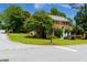 Attractive brick home on a corner lot with lush greenery and a well-manicured front yard at 10645 Tuxford Dr, Alpharetta, GA 30022