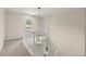 Well-lit hallway with white railing, carpet, and trim, providing access to various parts of the home at 10645 Tuxford Dr, Alpharetta, GA 30022