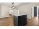 Large kitchen featuring a dark island with a white countertop and modern wood flooring throughout at 10645 Tuxford Dr, Alpharetta, GA 30022