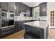 Elegant kitchen featuring gray cabinets, stainless steel appliances, and a white countertop on an island at 10645 Tuxford Dr, Alpharetta, GA 30022
