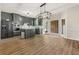 Open-concept kitchen featuring gray cabinetry, stainless steel appliances, and wood flooring throughout at 10645 Tuxford Dr, Alpharetta, GA 30022