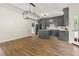 Spacious kitchen featuring an island, gray cabinets, stainless steel appliances, and wood flooring at 10645 Tuxford Dr, Alpharetta, GA 30022