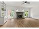 Inviting living room with a fireplace, built-in shelving, and French doors to the outdoors at 10645 Tuxford Dr, Alpharetta, GA 30022