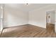 Spacious room with hardwood flooring, decorative wall panels, and elegant crown molding at 10645 Tuxford Dr, Alpharetta, GA 30022