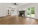 Bright living room features hardwood floors, a fireplace, and built-in shelves, perfect for entertaining and relaxation at 10645 Tuxford Dr, Alpharetta, GA 30022