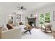 Spacious living room with fireplace, white walls and trim and hardwood floors, perfect for entertaining guests at 10645 Tuxford Dr, Alpharetta, GA 30022