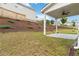Level backyard featuring a covered patio, offering a comfortable outdoor space for relaxation and entertainment at 1504 Lemon Balm Ct, Lawrenceville, GA 30045