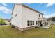 Backyard featuring a covered patio, manicured lawn, and a two-story home at 1504 Lemon Balm Ct, Lawrenceville, GA 30045