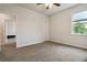 Neutral bedroom with carpet, a ceiling fan, and natural light from a window at 1504 Lemon Balm Ct, Lawrenceville, GA 30045