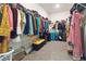 Spacious walk-in closet featuring ample shelving and storage solutions for organization at 1504 Lemon Balm Ct, Lawrenceville, GA 30045