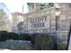 Alcove Creek community entrance sign with stone base and manicured landscaping at 1504 Lemon Balm Ct, Lawrenceville, GA 30045