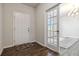 Inviting foyer with wood floors, leading to a bright office space through glass panel doors at 1504 Lemon Balm Ct, Lawrenceville, GA 30045